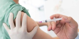 Trump Torches Vaccine Playbook Healthcare worker giving an intramuscular injection in upper arm