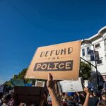protesters holding signs at a street demonstration