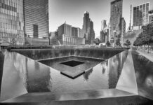 Ground Zero Gag Order Derails Trump Stop A memorial water feature surrounded by tall buildings in a city