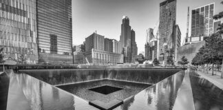 Ground Zero Gag Order Derails Trump Stop A memorial water feature surrounded by tall buildings in a city