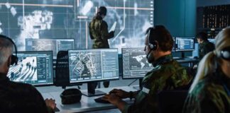 Ransomware Chaos Freezes 911 In California Military analysts at computers in a command center