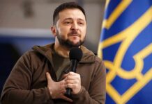 Ukraine Removes Key Washington Diplomat man holding a microphone with hand on chest