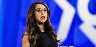 Lauren Boebert’s Son Faces Five Felony Charges Woman speaking on stage with arms outstretched