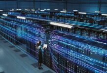 AI Data Center Transforms Rural America Technician with laptop in a large data center aisle