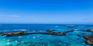 China Builds New Island Near Key Waters Boats anchored in turquoise lagoon with rocky islets