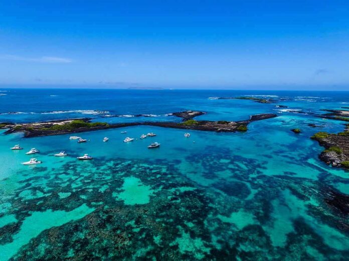 Boats anchored in turquoise lagoon with rocky islets