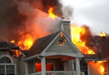 Manhunt Ends After Deadly Family Tragedy House engulfed in flames with heavy smoke from the roof