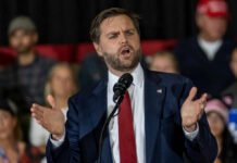 Man in suit speaking at a podium