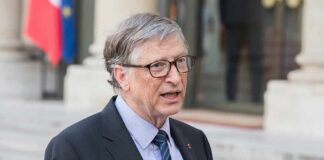 man in suit speaking outdoors