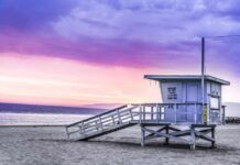 Morning Swim Turns Deadly Lifeguard tower on a sandy beach at sunset with colorful sky