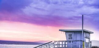 Morning Swim Turns Deadly Lifeguard tower on a sandy beach at sunset with colorful sky