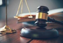 Outrage Brewing: Military Paper Put On Leash Judge's gavel on block with scales of justice