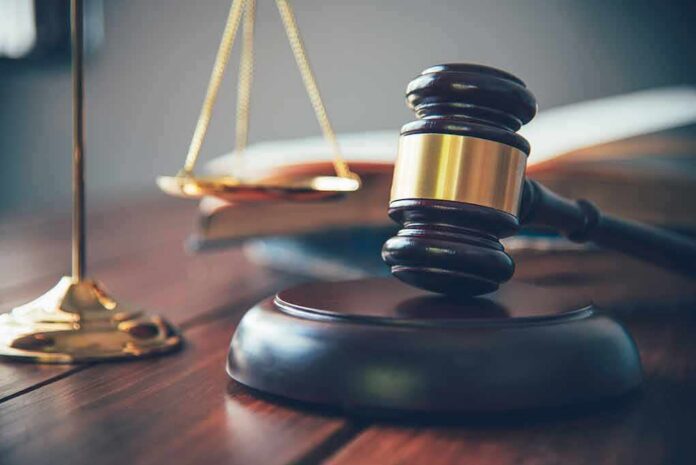 shutterstock_1147399469-1 Judge's gavel on block with scales of justice