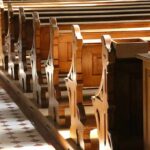 wooden church pews in sunlight
