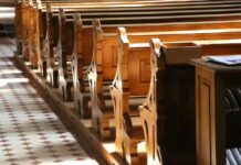 Undercover Feds Inside Churches? wooden church pews in sunlight
