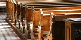wooden church pews in sunlight