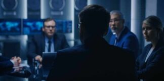 FBI Turmoil: Top Aide Suddenly Quits Business professionals in a dim conference room meeting