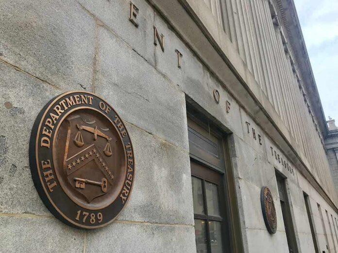 shutterstock_1274705839-1 U.S. Treasury building exterior with bronze seal on stone wall