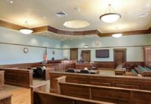 Rage Politics Hits Massachusetts Courtroom Empty courtroom with wooden benches and judge's bench