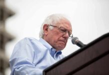 Oligarchy Warning Erupts Before UN Bernie Sanders speaking at a podium with a microphone