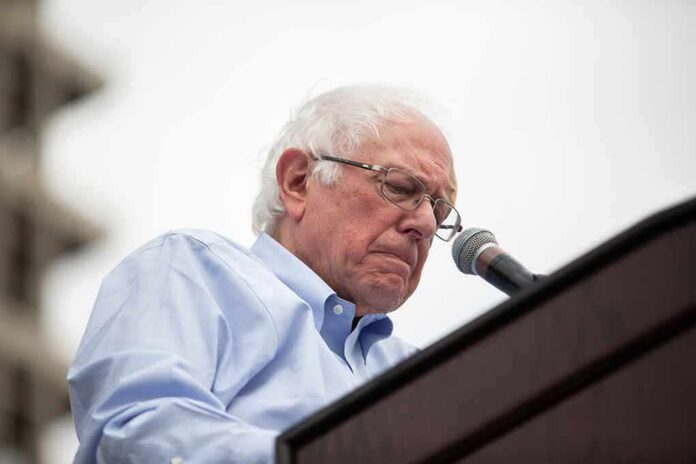 shutterstock_1402022795 Bernie Sanders speaking at a podium with a microphone