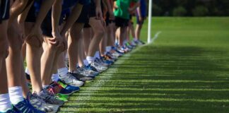 Governor Challenges Authority Behind Sports Rule Runners lined up at a starting line on grass