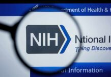 Magnifying glass focuses on NIH logo on a website