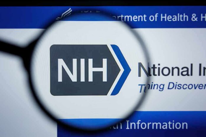 Magnifying glass focuses on NIH logo on a website