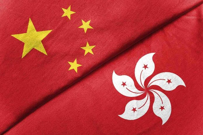 China and Hong Kong flags overlapping on red fabric