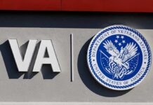 VA logo and Department of Veterans Affairs seal on building wall
