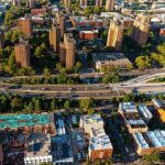 Aerial view of city high-rise apartments and highway