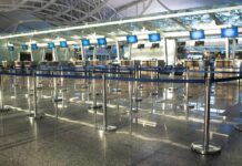 Airport check-in counters with empty queue barriers