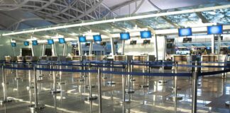 Airport check-in counters with empty queue barriers