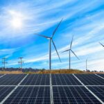 Solar panels with wind turbines in a sunny landscape