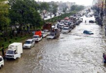 Emergency Declarations Blanket The Coast Flooded city street with stranded vehicles and traffic jam