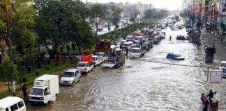 Emergency Declarations Blanket The Coast Flooded city street with stranded vehicles and traffic jam