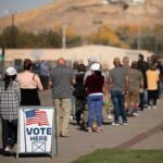 voters standing in a long line outside a polling place