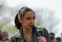 Media Spins, AOC Pumps The Brakes AOC speaking into a handheld microphone outdoors
