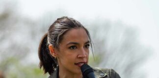 Media Spins, AOC Pumps The Brakes AOC speaking into a handheld microphone outdoors