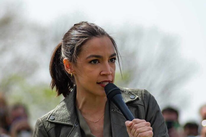 AOC speaking into a handheld microphone outdoors