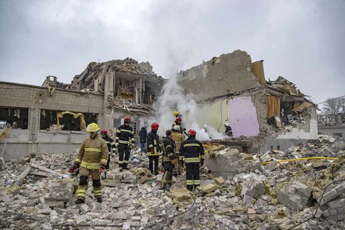 shutterstock_2132623665-1 Firefighters search rubble of a partially collapsed building