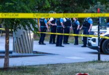 Red Zone Nightmare Hits California Campus police officers stand behind caution tape at a park scene