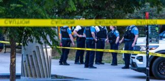 Red Zone Nightmare Hits California Campus police officers stand behind caution tape at a park scene