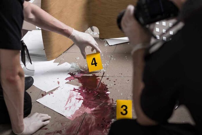 forensic investigators documenting a bloodstained crime scene