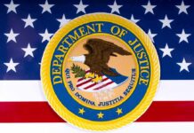 DOJ Pushes Pause On Trans Care Department of Justice seal on American flag background