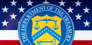 Treasury And Senator Clash Over Rising Rates U.S. Department of the Treasury seal over American flag