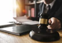 Life Term After Deadly Border Chase Judge's gavel on desk with person reading documents in background