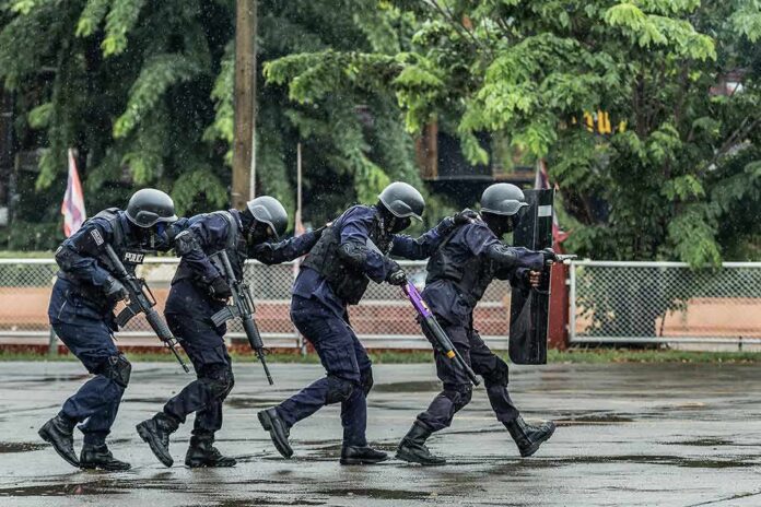 Police tactical team advancing in rain