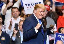 10 Million Tons? Trump Teases a Giant Donald Trump at a rally raising his fists on stage