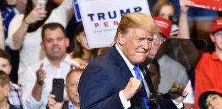 10 Million Tons? Trump Teases a Giant Donald Trump at a rally raising his fists on stage
